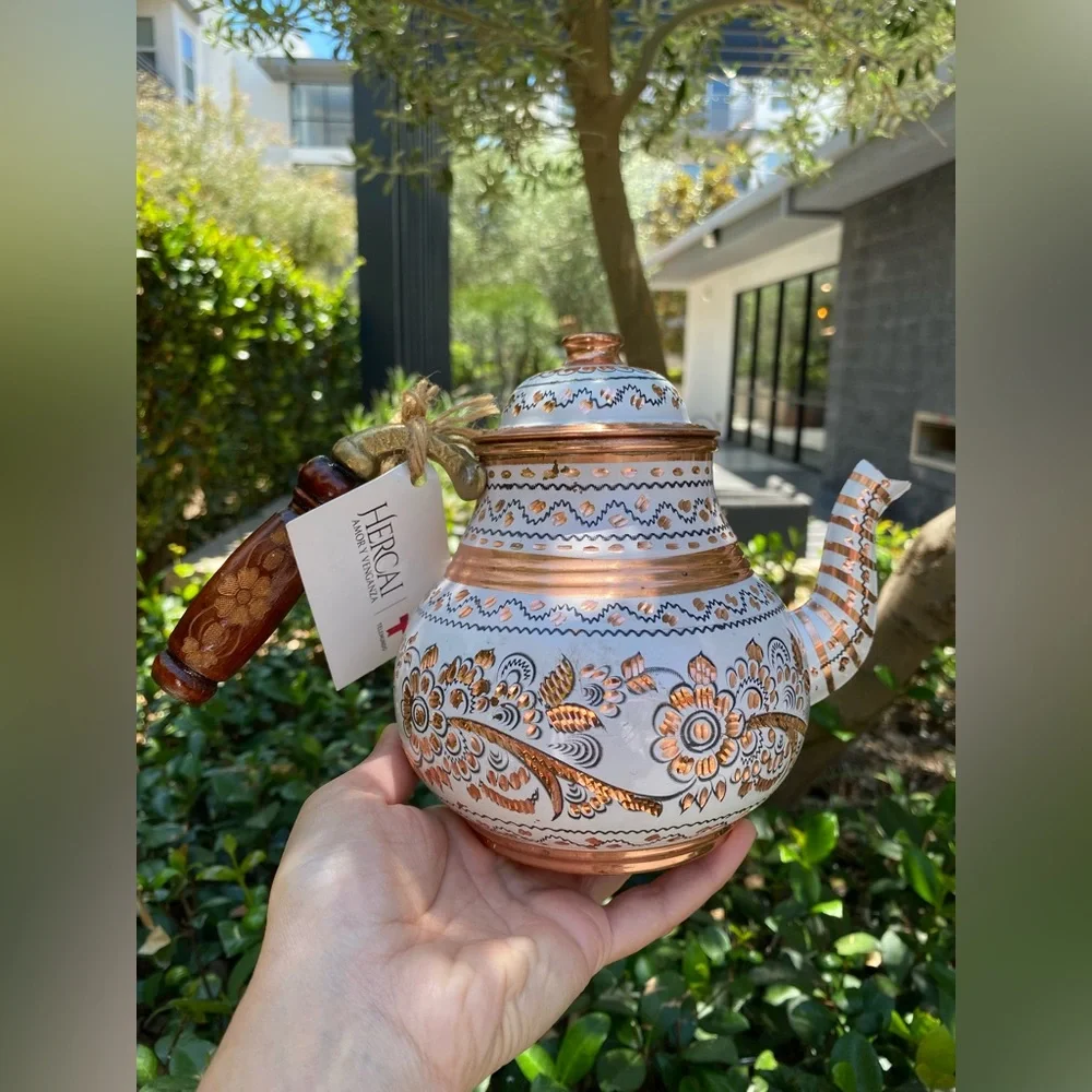 This handmade, white-painted Turkish copper teapot set features traditional